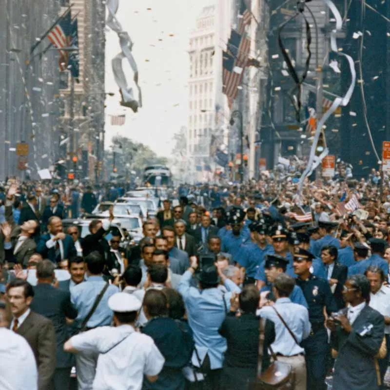 A crowd celebrating in a city street